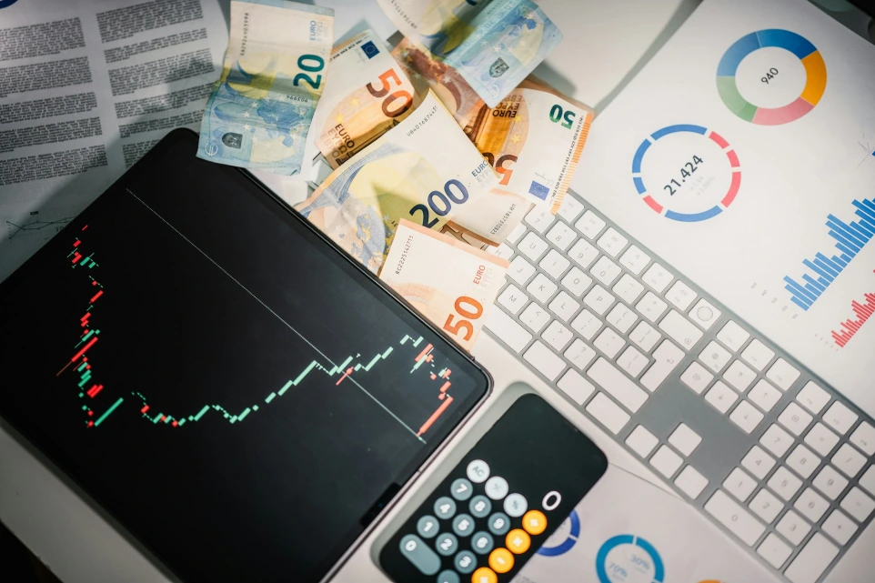 A calculator sitting on top of a pile of money